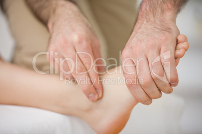 Two fingers touching and massaging a foot