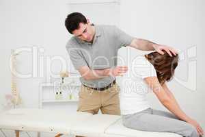 Physiotherapist looking at the spinal column of a woman