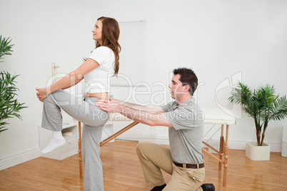 Serious woman stretching her leg