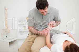 Physiotherapist looking at the wrist of a patient