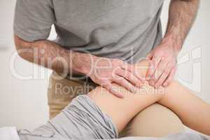 Physiotherapist massaging the knee of a woman