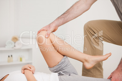 Osteopath working on a leg of a woman