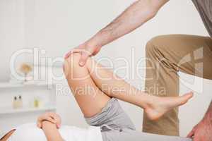 Osteopath working on a leg of a woman