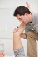 Serious osteopath holding a leg