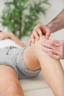 Fingers of a doctor massaging a leg