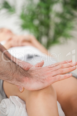 Osteopath using his hand palm to massage a knee