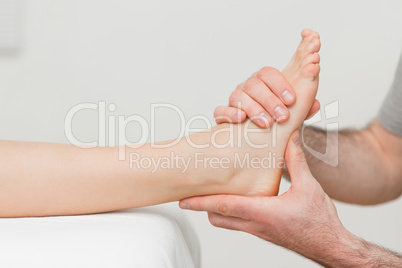 Hands of an osteopath massaging a foot