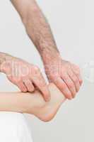 Physiotherapist touching the foot of a patient
