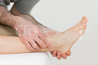 Physiotherapist working on the shin bone of a patient