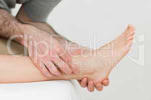 Physiotherapist working on the shin bone of a patient