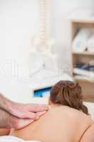 Back of the woman being massaged by a masseur