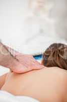 Chiropractor massaging the back of his patient