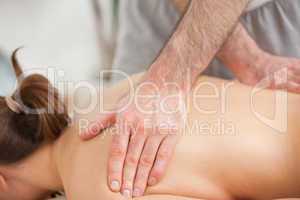 Woman lying on the belly while being massaged on his back