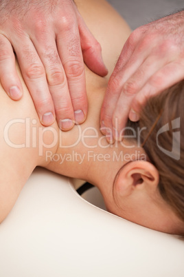 Doctor massaging the neck of his patient