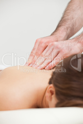 Close-up of woman being massaged by a doctor