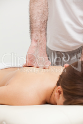 Doctor massaging his patient while using the back of his hand