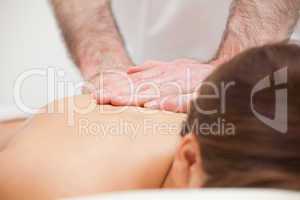 Close-up of a doctor massaging the back of a woman