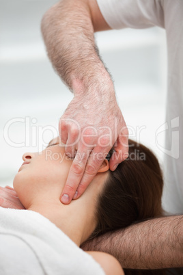 Therapist pressing with two fingers on the neck of his patient