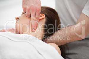 Doctor manipulating the neck of a woman while using his fingerti