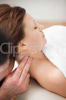 Doctor massaging the neck of woman while holding her head