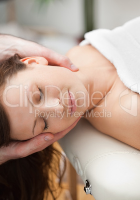 Peaceful woman being massaging on the neck by a therapist