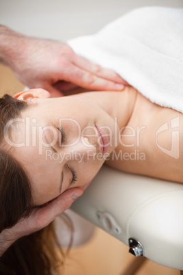 Neck of a patient being massaged by a chiropractor