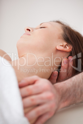 Close-up of neck of woman beig manipulating by a therapist