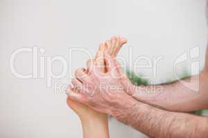 Doctor manipulating the foot of his patient