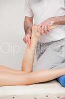 Podiatrist massaging the ankle of a woman