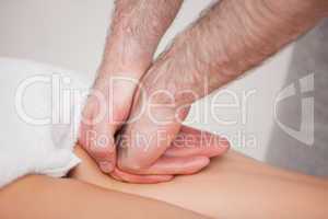 Practitioner massaging the thigh of his patient