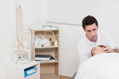Neck of woman being manipulated by the chiropractor