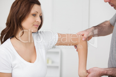 Doctor examining the arm of his patient