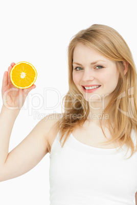 Smiling woman presenting an orange Smiling woman presenting an orange