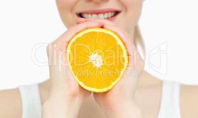 Close up of a woman holding an orange