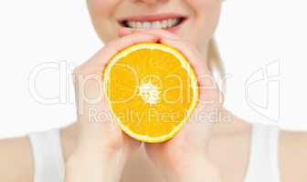 Close up of a woman holding an orange