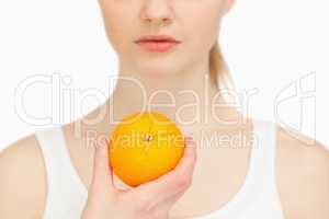 Woman holding an orange