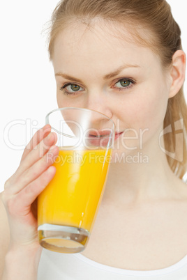 Woman drinking a glass of orange juice