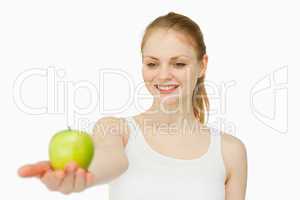 Cheerful woman presenting an apple