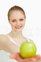 Young woman presenting an apple