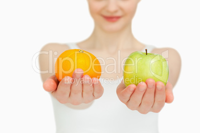 Close up of a woman presenting fruits