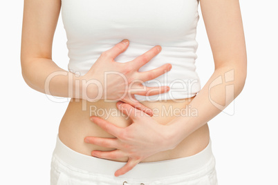Woman touching her belly with her hands