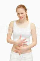 Suffering woman placing her hands on her stomach