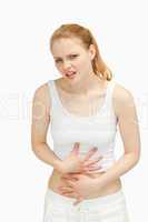 Woman placing her hands on her painful stomach