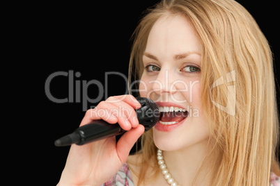 Young blond-haired woman singing