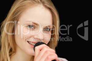 Young woman smiling while singing