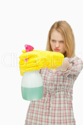 Young woman holding a spray bottle