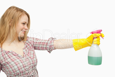 Blond-haired woman holding a spray bottle