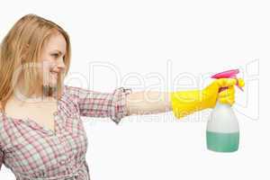 Blond-haired woman holding a spray bottle