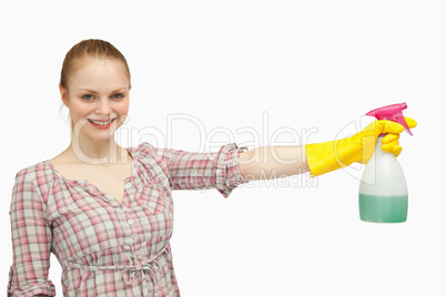 Cheerful woman holding a spray bottle