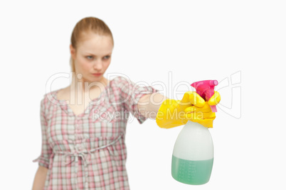 Serious woman holding a spray bottle